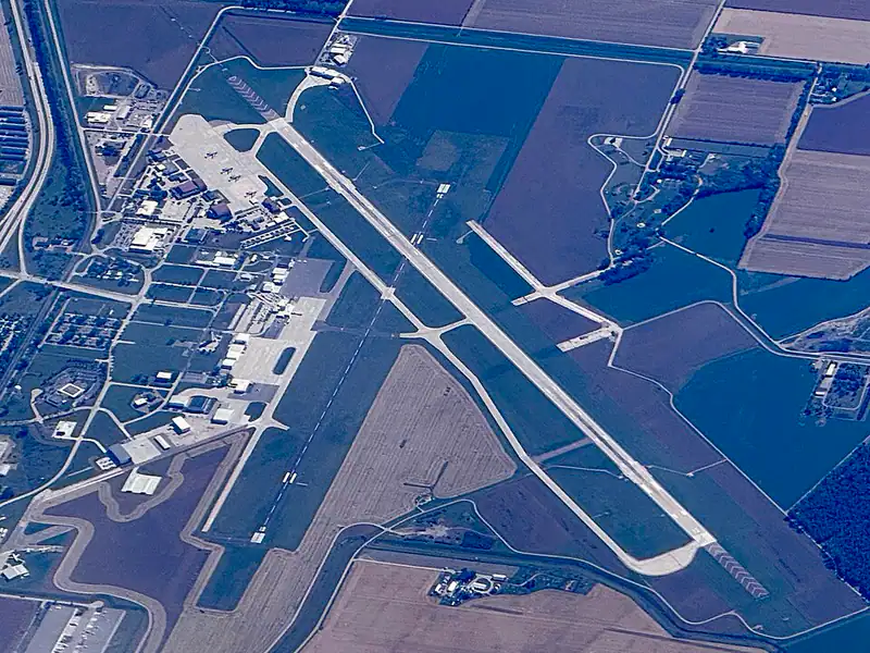 Aerial view of an airfield with two crossing runways among farm fields