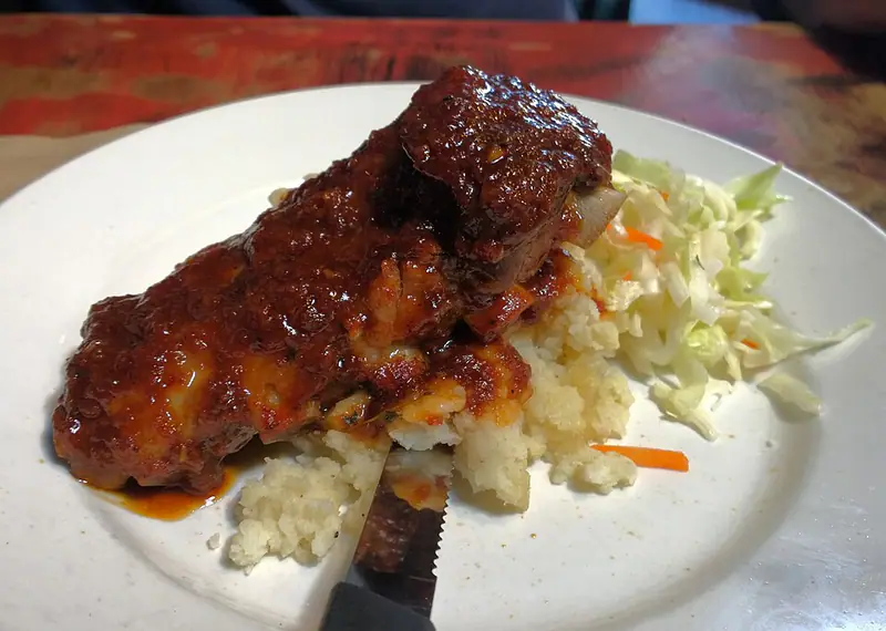 Glazed jerk chicken with rice and shredded cabbage