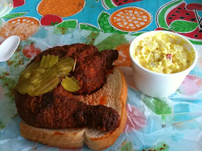 Fried hot chicken on white bread with pickles
